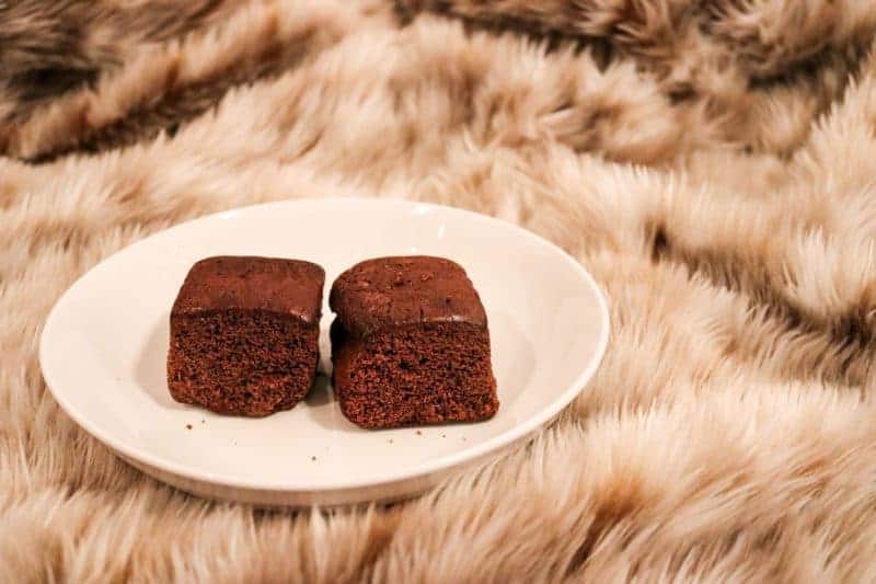 A Beginner’s Guide to 3 Days in Amsterdam. Two brownies on a white plate, resting on a fur rug.